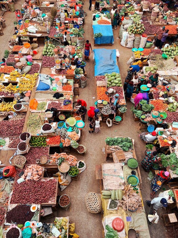 Colorful aerial photo capturing a busy food market with diverse fresh produce and market stalls.